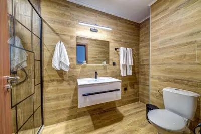a bathroom with a toilet and a sink and a shower at Deer Lake 521 at Oak Residence Hotel & Relax in Smolyan