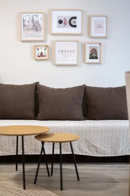 a living room with a couch and two tables at Cozy home next to Aliosha - Boho Stay in the heart of Plovdiv in Plovdiv