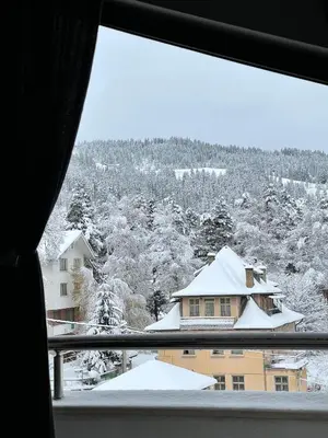a view from a window of a house covered in snow at Мансарда с фантастични гледки и две спални in Chepelare