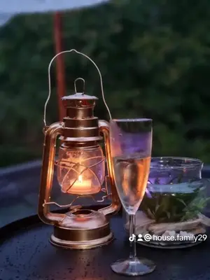 a lantern and a wine glass on a table at Green View 1 in Skrino