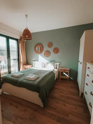 a bedroom with a bed with a green wall at Vitosha View Apartment & Free Parking in Sofia