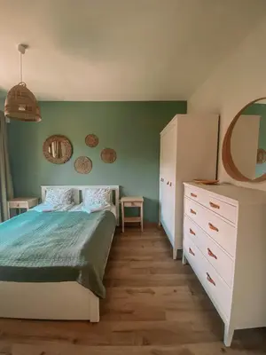 a bedroom with a bed and a dresser and a mirror at Vitosha View Apartment & Free Parking in Sofia