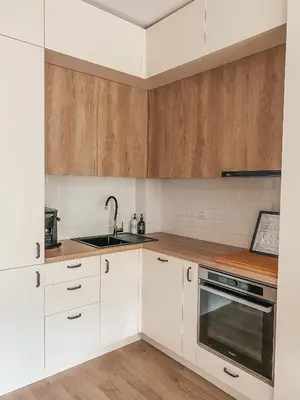 a kitchen with white cabinets and a sink at Vitosha View Apartment & Free Parking in Sofia