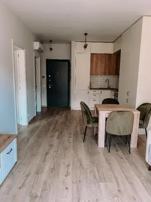 a kitchen and dining room with a table and chairs at Vitosha View Apartment & Free Parking in Sofia