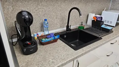 a kitchen counter with a kitchen sink with a blender at Urban Comfort 1BR near South Park with Balcony in Sofia