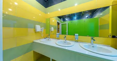 a bathroom with three sinks and a large mirror at Green Cube Capsule Hostel in Sofia