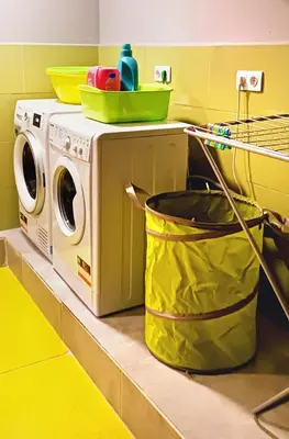 a kitchen with a washing machine and a bucket at Green Cube Capsule Hostel in Sofia