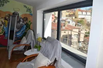 a room with two chairs and a large window at Artistic loft with AMAZING VIEW in Plovdiv