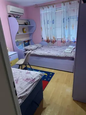 a small bedroom with two beds and a window at Къща Бети самостоятелни апартаменти с двор край Пловдив in Skutare