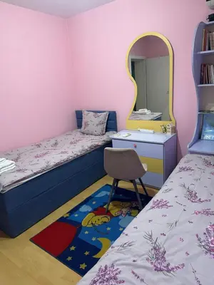 a bedroom with a bed and a mirror and a chair at Къща Бети самостоятелни апартаменти с двор край Пловдив in Skutare