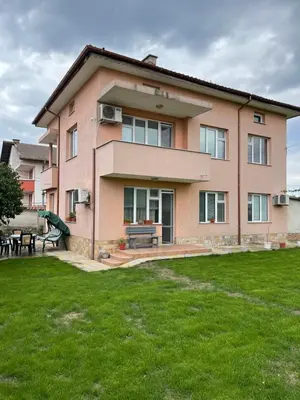 a house with a green lawn in front of it at Къща Бети самостоятелни апартаменти с двор край Пловдив in Skutare