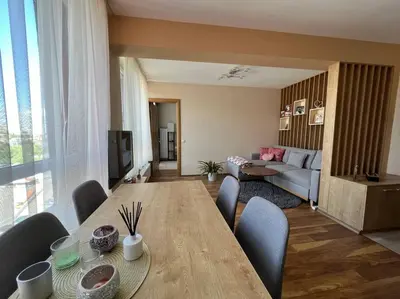 a living room with a long wooden table and chairs at Cozy and bright apartment in Sofia