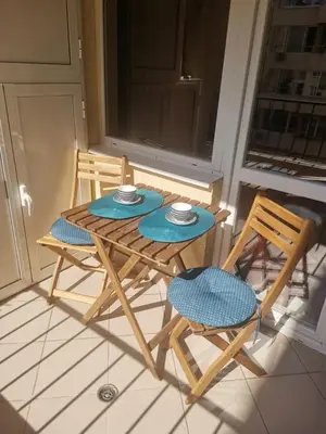 a table and two chairs on a porch at Top luxury apartment, great location in Sofia