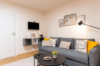 a living room with a blue couch and a table at Our Place in Sofia