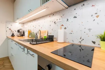 a kitchen with a counter with a wall with butterflies at Our Place in Sofia