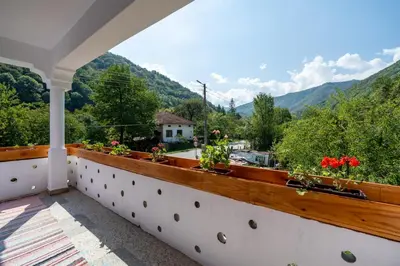 a balcony with a view of the mountains at Къща за гости Остриля in Cherni Vit