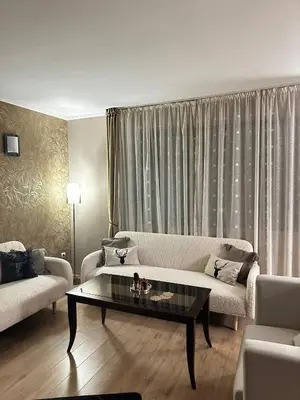 a living room with a couch and a coffee table at STENATA Sport Apartments in Pamporovo