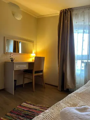 a bedroom with a desk and a mirror and a bed at STENATA Sport Apartments in Pamporovo