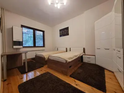 a bedroom with two beds and a desk in it at Luxury apartment Sofia top centre in Sofia