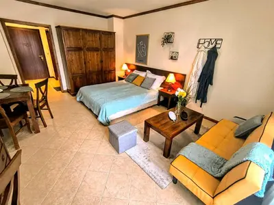 a bedroom with a bed and a couch at Luxury SPA Apartments TOP resort Bansko - incl wellness in Bansko
