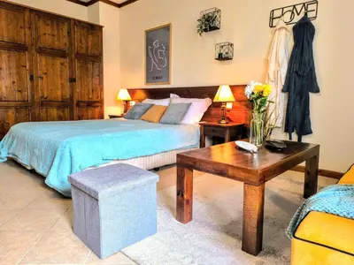 a bedroom with a bed and a coffee table at Luxury SPA Apartments TOP resort Bansko - incl wellness in Bansko