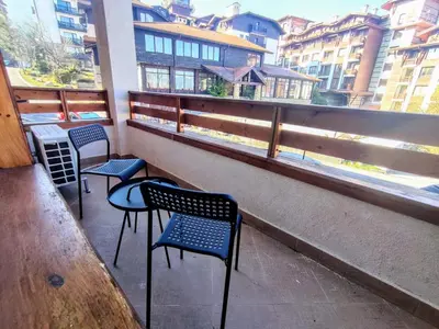 three chairs and a table in front of a window at Luxury SPA Apartments TOP resort Bansko - incl wellness in Bansko