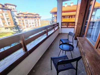 two chairs and a table on a balcony at Luxury SPA Apartments TOP resort Bansko - incl wellness in Bansko