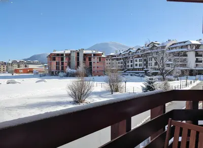 a view from the balcony of a building in the snow at Belvedere Holiday Club H41 in Bansko