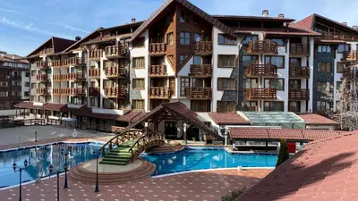a large hotel with a swimming pool in front of it at Belvedere Holiday Club H41 in Bansko