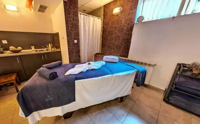 a bedroom with a large bed with blue sheets at Belvedere Holiday Club H41 in Bansko
