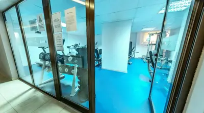 a gym with glass walls and tread machines at Belvedere Holiday Club H41 in Bansko