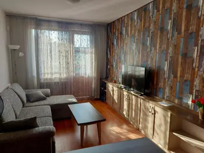 a living room with a couch and a flat screen tv at Belvedere Holiday Club H41 in Bansko