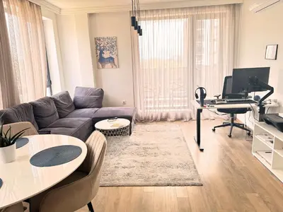 a living room with a couch and a table at Urban Exec Suite with Free Gym Pass, Full Office Setup and Designated Parking Space in Plovdiv