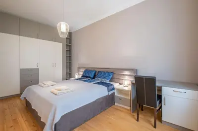 a bedroom with a bed and a desk with a chair at Gorgeous 2 BDRM fully equipped flat, TOP location in Sofia