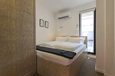 a bedroom with a bed in a room with a mirror at Old Town View in Plovdiv