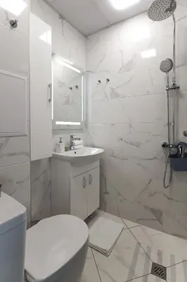 a white bathroom with a toilet and a sink at Old Town View in Plovdiv