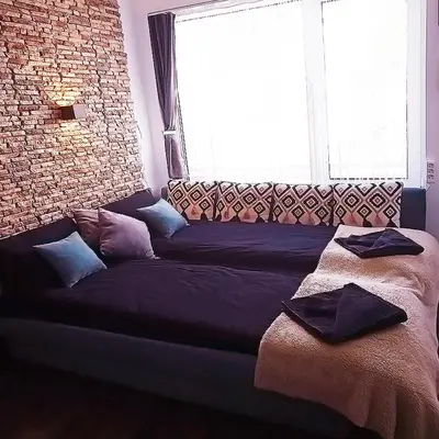 a couch in a room with a large window at Alis in Sofia