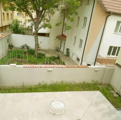 an empty plate on the ground in a yard with buildings at Alis in Sofia