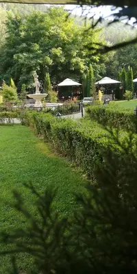 a park with a fountain and a statue in the grass at Апартамент и Студия 