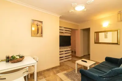 a living room with a couch and a tv at Charming Artistic Central Apartment in Sofia