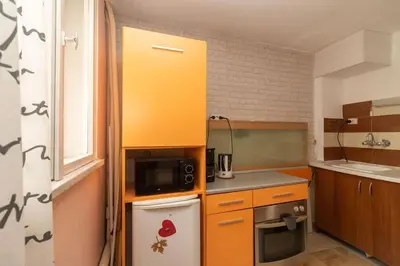 a small kitchen with a microwave and a stove at Charming Artistic Central Apartment in Sofia