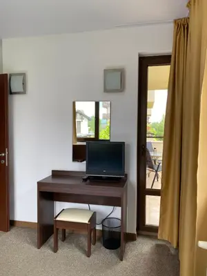 a desk with a computer on it with a mirror at M&R Apartment C13 - SPA Terra Complex in Razlog