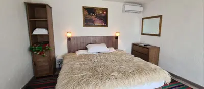 a bedroom with a bed with a tufted bed sidx sidx sidx at стаи за гости Никол in Starosel