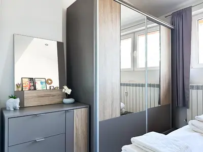 a bedroom with a mirror and a bed at Budget Stay Near Sofias Lions Bridge in Sofia