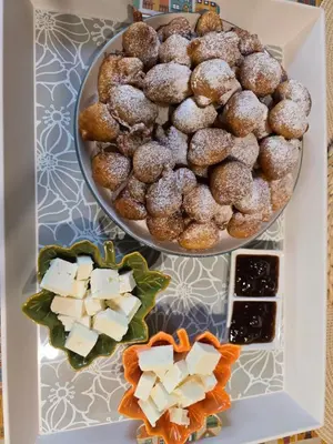 a plate of donuts and other desserts on a table at Къща за гости в селска местност in Petrich