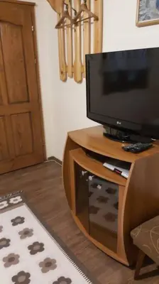 a television sitting on top of a wooden stand at Къща за гости в селска местност in Petrich