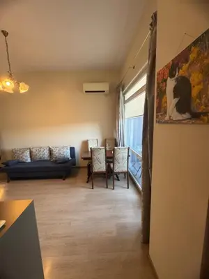 a living room with a couch and a table at Лукс апартамент Базилика отделен вход in Sandanski