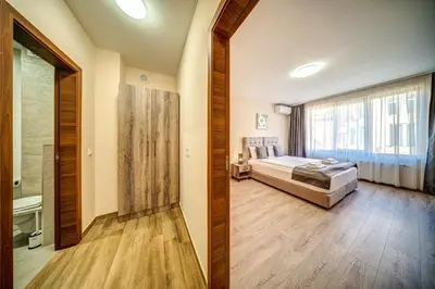 a bedroom with a bed and a large window at VALEMO Apart House in Devin