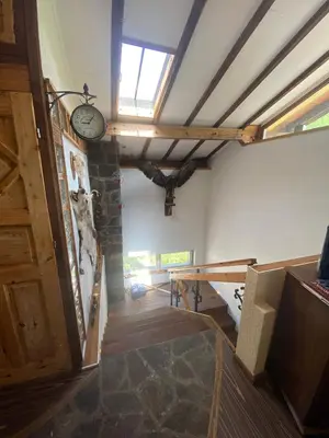 a room with a door and a clock on the wall at КЪЩА ЗА ГОСТИ ВОДЕНИЦАТА in Devin