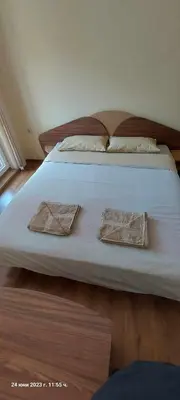 a large white bed with two pillows on it at КЪЩА ЗА ГОСТИ ВОДЕНИЦАТА in Devin